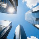 Tall glass skyscrapers against blue sky